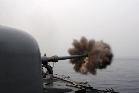 US Navy 110610-N-SP676-307 The guided-missile frigate USS Ford (FFG 54) fires its MK 75 76mm-3-inch gun at a target during a Cooperation Afloat Rea