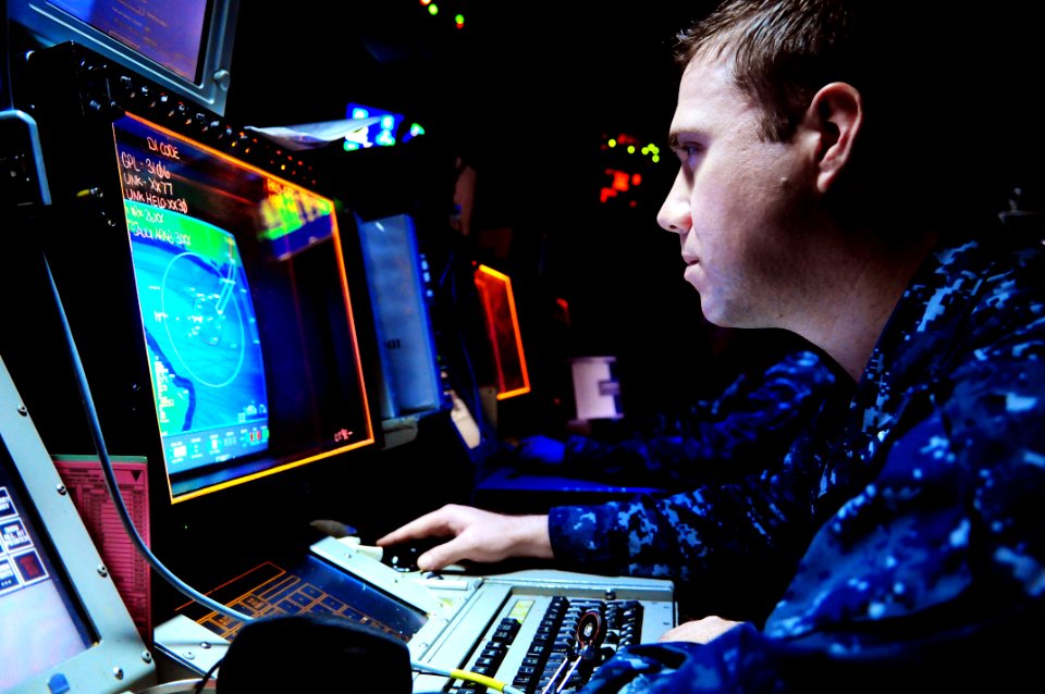 US Navy 110611-N-UO379-185 Operations Specialist 2nd Class Stephen Sittner, from Denver, identifies and tracks air contacts in the Combat Direction