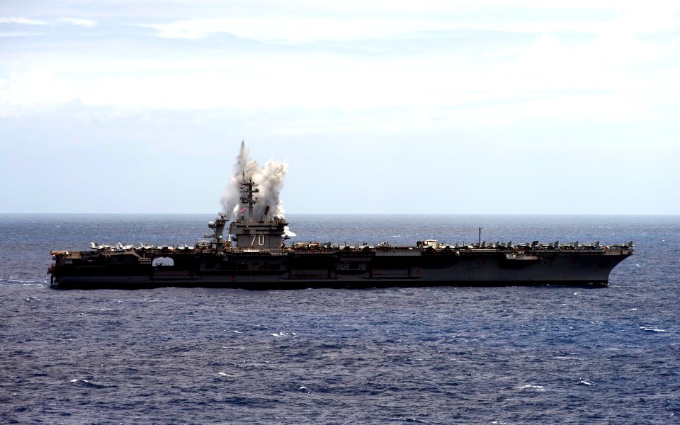 US Navy 110611-N-TU221-562 F-A-18F Super Hornet strike fighters drop ordnance off the port side of the Nimitz-class aircraft carrier USS Carl Vinso