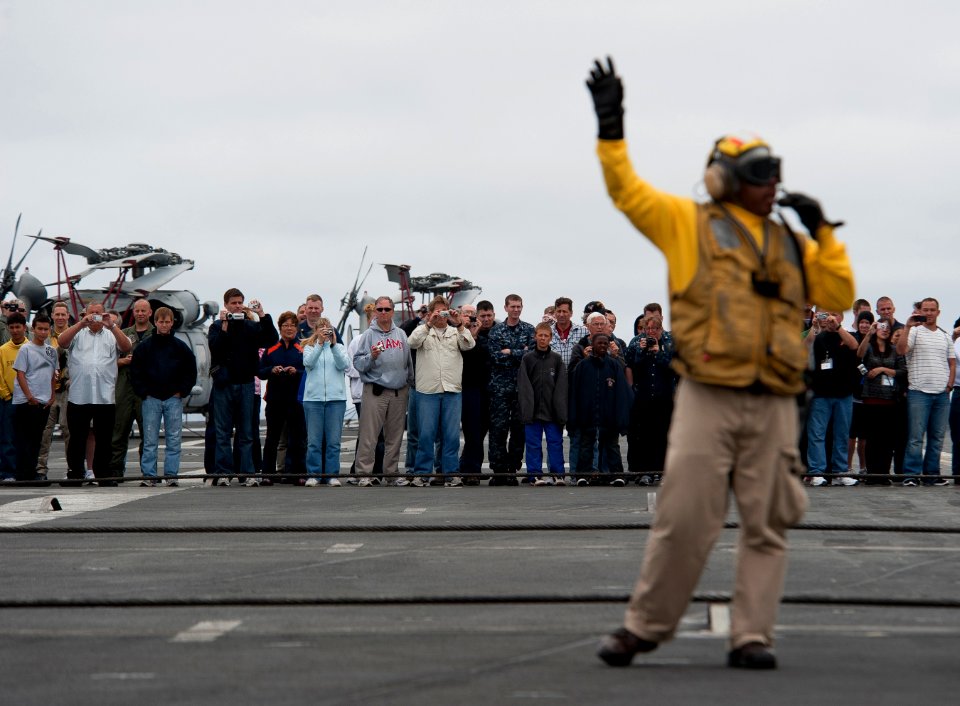 US Navy 110613-N-DR144-108 Sailors, friends and family watch as flight deck personnel demonstrate aircraft firefighting drills aboard the Nimitz-cl