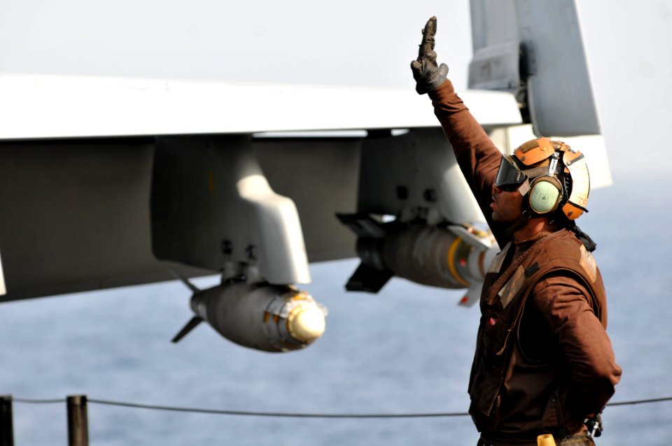 US Navy 110613-N-GL340-011 A plane captain signals to a pilot in an aircraft aboard the aircraft carrier USS Ronald Reagan (CVN 76)