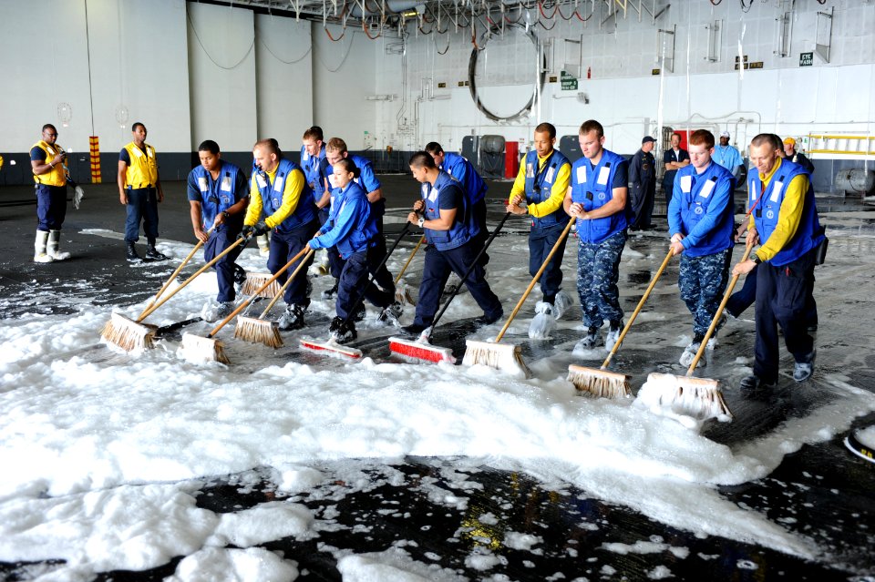 US Navy 110614-N-AU622-047 Sailors assigned to the air department aboard the aircraft carrier USS Dwight D. Eisenhower (CVN 69) sweep aqueous film