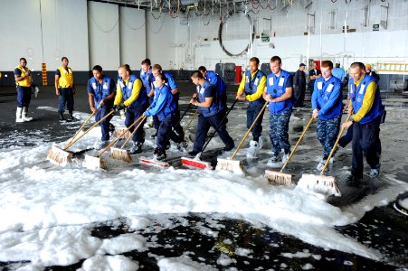 US Navy 110614-N-AU622-047 Sailors assigned to the air department aboard the aircraft carrier USS Dwight D. Eisenhower (CVN 69) sweep aqueous film