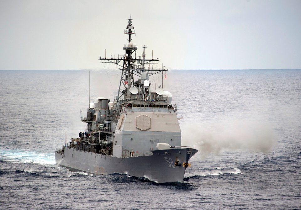 US Navy 110612-N-DR144-433 The Ticonderoga-class guided-missile cruiser USS Bunker Hill (CG 52) fires a salvo from its 5-inch gun
