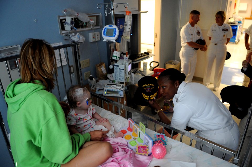 US Navy 110614-N-AD372-028 Command Master Chief Shay Fortsom from the guided-missile destroyer USS Sampson (DDG 102) makes a child an honorary Sail