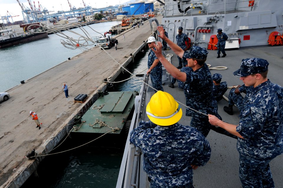US Navy 110614-N-TB177-069 Sailors aboard the guided-missile destroyer USS Truxtun (DDG 103) throw a line to personnel on the pier as the ship pull photo