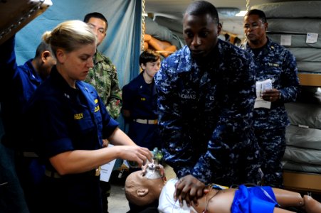 US Navy 110615-F-CF975-019 Lt. Carla Henley, left, from San Diego, and Hospitalman Julian Thomas, from Jacksonville, Fla., gives practice CPR durin