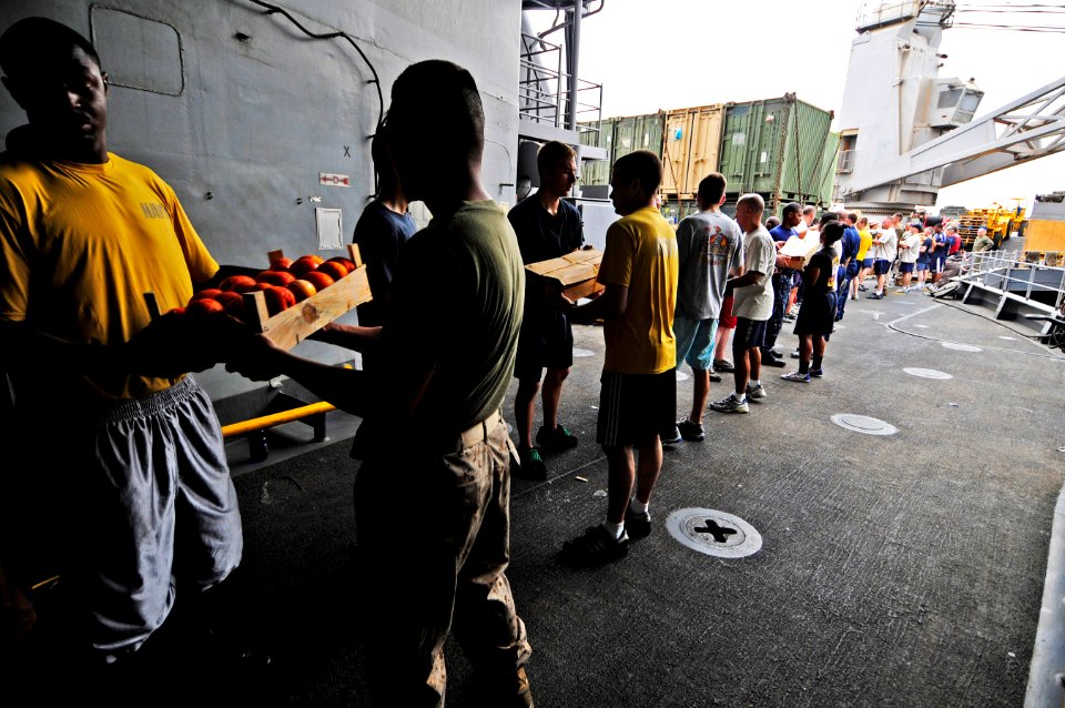 US Navy 110613-N-RC734-093 Sailors and Marines participate in a working party to move supplies during a vertical replenishment aboard USS Comstock