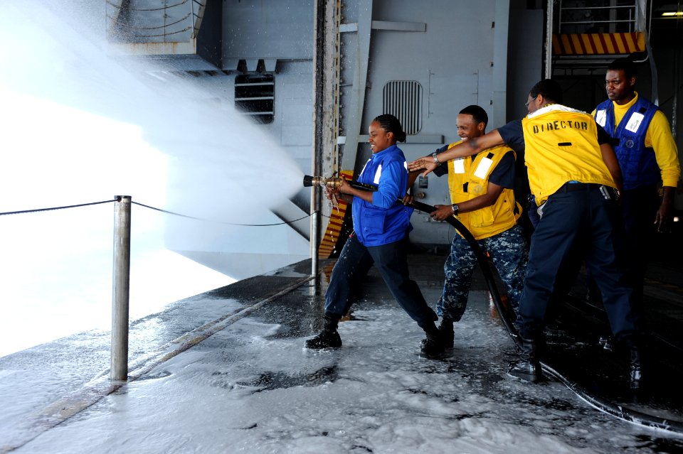 US Navy 110614-N-AU622-011 Aviation Boatswain's Mate (Handling) 3rd Class Mary Anne Francis discharges on a 2 1-2