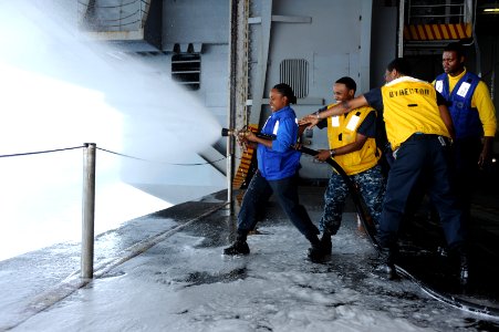 US Navy 110614-N-AU622-011 Aviation Boatswain's Mate (Handling) 3rd Class Mary Anne Francis discharges on a 2 1-2