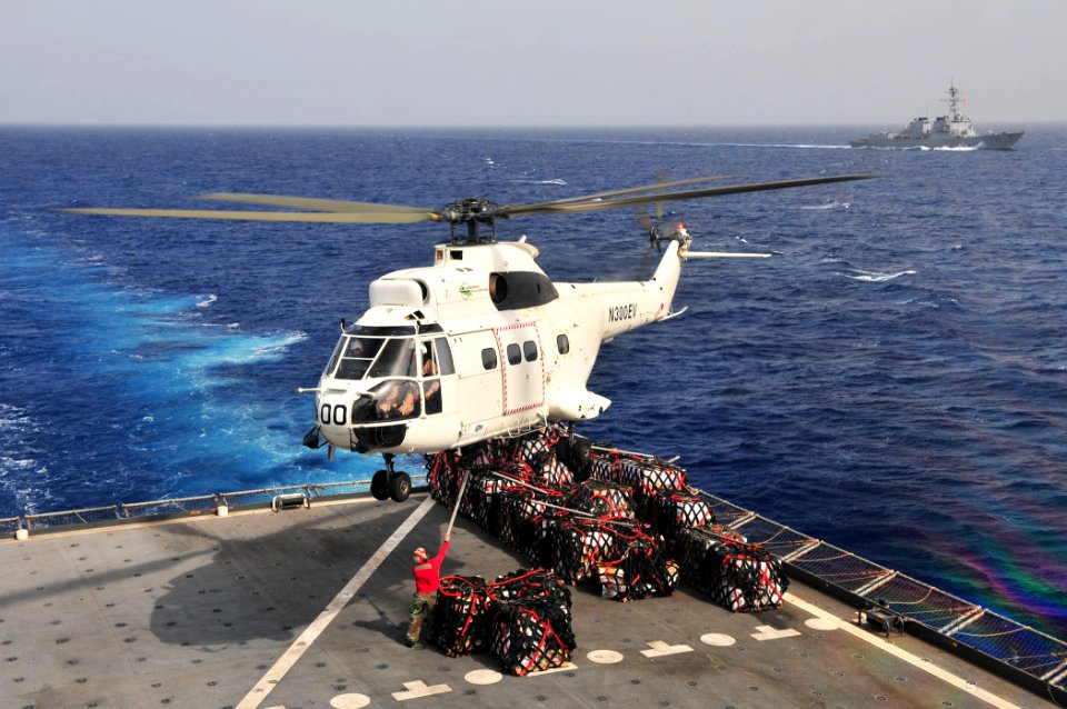 US Navy 110612-N-ZS026-450 A civilian mariner aboard the Military Sealift Command dry cargo and ammunition ship USNS Alan Shepard (T-AKE 3) attache