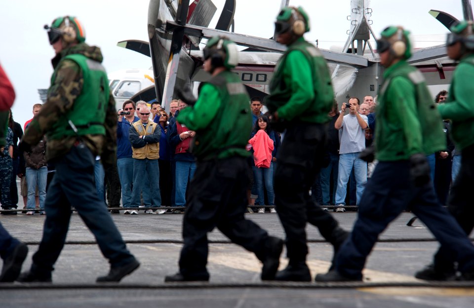 US Navy 110613-N-DR144-121 Sailors, friends and family watch as flight deck personnel demonstrate aircraft firefighting drills on the flight deck o