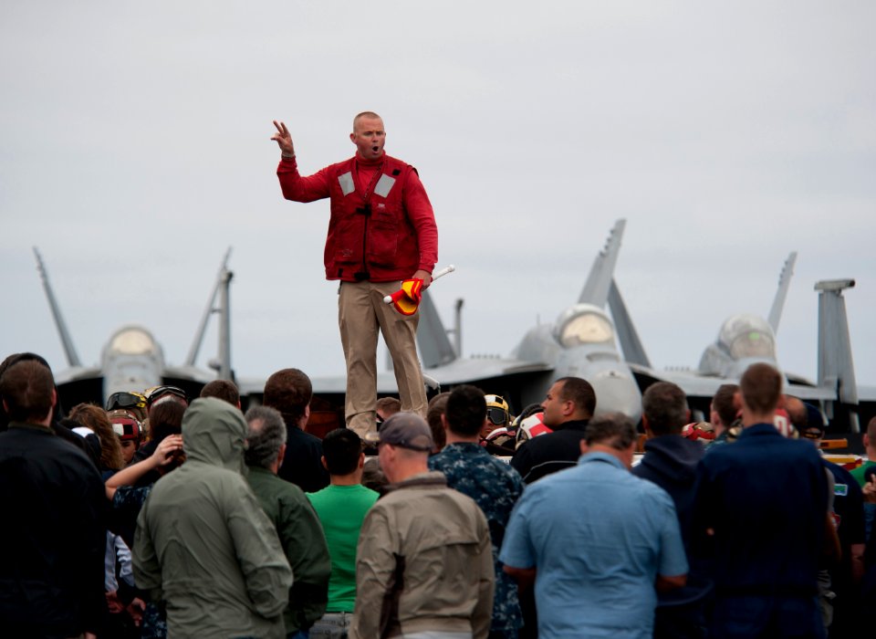US Navy 110613-N-DR144-015 Air boatswain Lt. Karl Thomsen briefs Sailors, friends and family as flight deck personnel prepare to demonstrate aircra