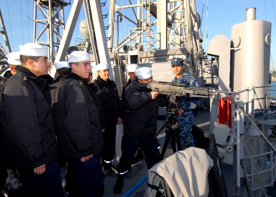 US Navy 110613-N-ZI300-071 Gunner's Mate 1st Class Enrique Cruz leads a group of Chilean navy recruits, called grumetes, on a tour of the guided-mi
