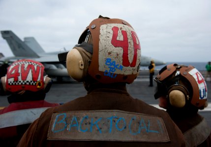 US Navy 110614-N-DR144-672 Sailors send a farewell to pilots and aircraft s they depart USS Carl Vinson (CVN 70) completing more than six months at