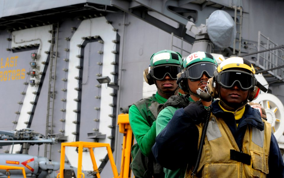 US Navy 110613-N-GZ277-180 Sailors participate in a flight deck firefighting demonstration for embarked friends and family during a tiger cruise ab