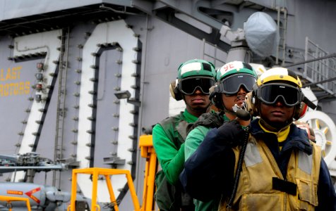 US Navy 110613-N-GZ277-180 Sailors participate in a flight deck firefighting demonstration for embarked friends and family during a tiger cruise ab