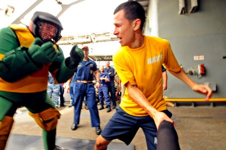 US Navy 110613-N-RC734-152 Culinary Specialist Seaman Recruit Nicholas Suarez, right, confronts Information Systems Technician 2nd Class Brandon Lu