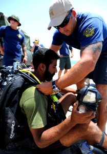 US Navy 110615-N-OT964-210 Chief Navy Diver Aaron Knight, assigned to Commander, Task Group (CTG) 56.1, conducts a pre-dive equipment inspection