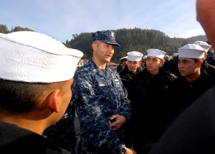 US Navy 110613-N-ZI300-118 Electronics Technician 1st Class Fred Hannah discusses U.S. Navy uniforms with a group of Chilean navy recruits, called