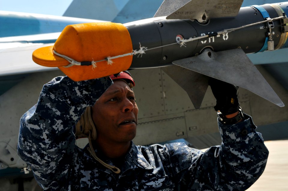 US Navy 110617-N-GO535-113 Aviation Ordnanceman 1st Class Corwyn Booker inspects the fin assembly of an AIM-9 Sidewinder air-to-air missile during