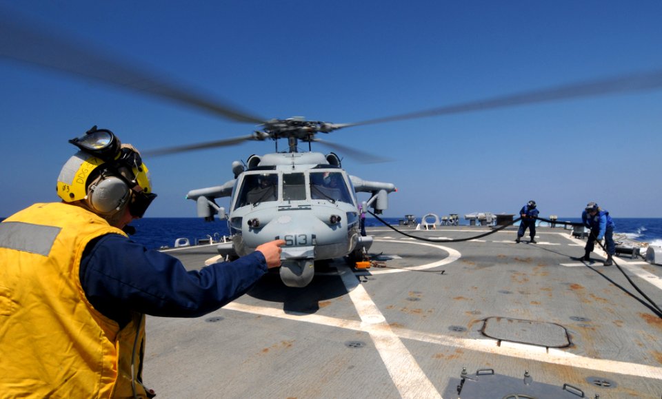 US Navy 110616-N-XQ375-182 Sailors refuel an MH-60S Sea Hawk helicopter from Helicopter Sea Combat Squadron (HSC) 9 aboard the guided-missile destr