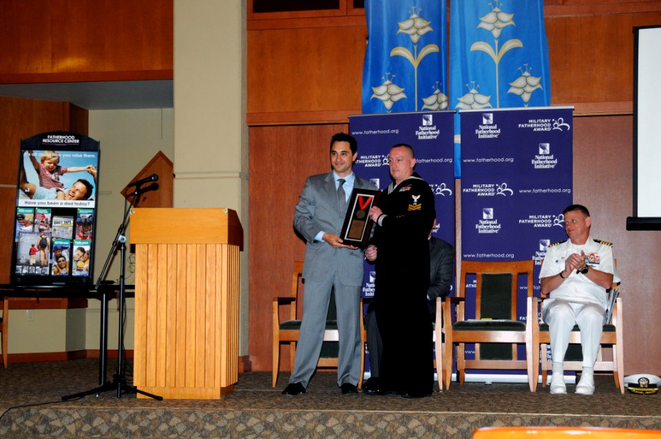 US Navy 110616-N-AE328-003 Vincent DiCaro, vice president of public affairs for the National Fatherhood Initiative, presents Logistics Specialist 1