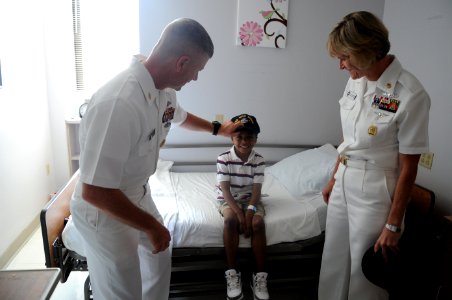 US Navy 110614-N-AD372-035 Master Chief Petty Officer of the Navy (MCPON) Rick D. West makes a child an honorary Sailor with a command ball cap fro