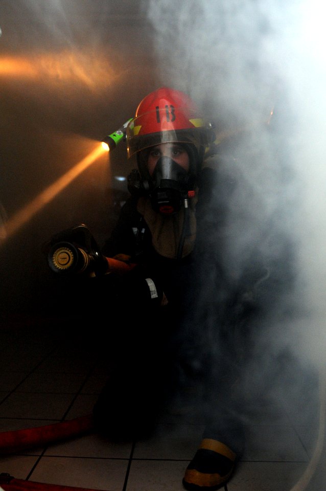 US Navy 110617-N-YC505-112 A Sailor simulates fighting a fire during a general quarters training exercise aboard the aircraft carrier USS George H