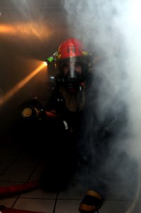 US Navy 110617-N-YC505-112 A Sailor simulates fighting a fire during a general quarters training exercise aboard the aircraft carrier USS George H