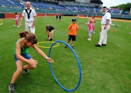 US Navy 110614-N-SH953-505 Sailors assigned to USS Constitution watch a child run through a hula hoop at the YMCA fitness challenge during Chattano photo