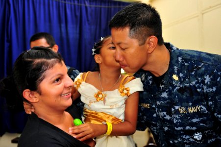 US Navy 110618-F-NJ219-086 A child kisses Lt. Kirby Jahnke, a nurse from Orlando, Fla., after her surgical screening at Padre Gasper Garcia Laviana