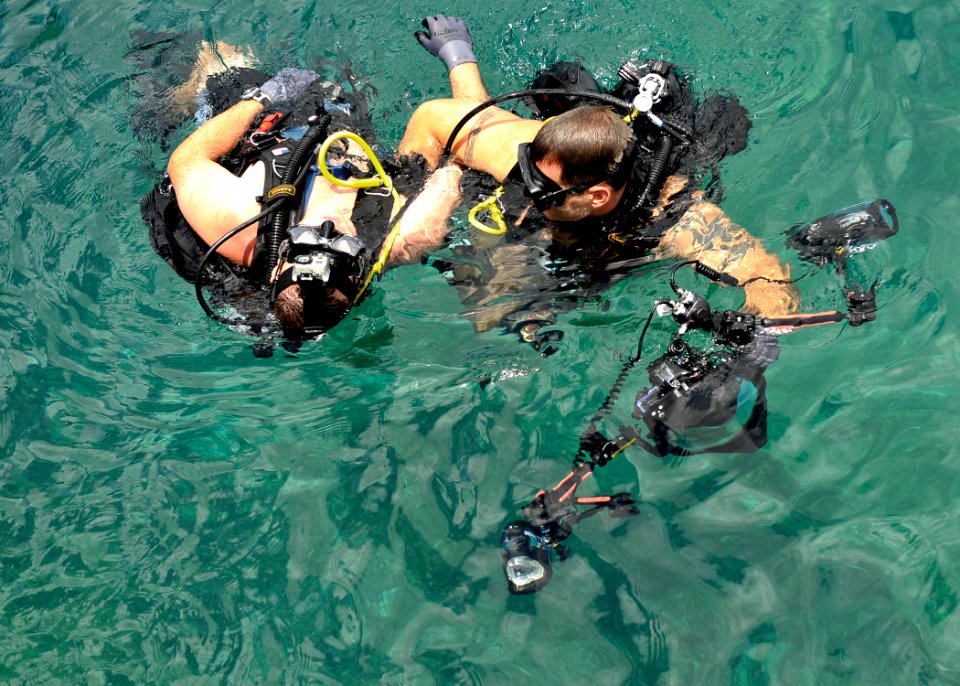 US Navy 110614-N-KB666-435 Mass Communication Specialist 1st Class Jayme Pastoric helps Chief Hospital Corpsman Nathanael Warren during a downed di
