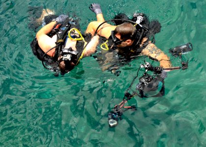 US Navy 110614-N-KB666-435 Mass Communication Specialist 1st Class Jayme Pastoric helps Chief Hospital Corpsman Nathanael Warren during a downed di photo