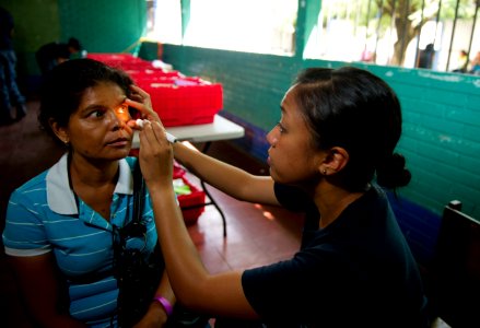 US Navy 110619-N-RM525-137 Lt. Patricia Salazar, from San Francisco, examines a patient at the Escuela Humberto Mendez Juarez medical site during a photo