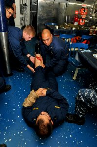 US Navy 110617-N-NL541-068 Chief Hospital Corpsman Edinito Purog, assigned to the guided-missile frigate USS Thach (FFG 43), uses Midshipman 1st Cl