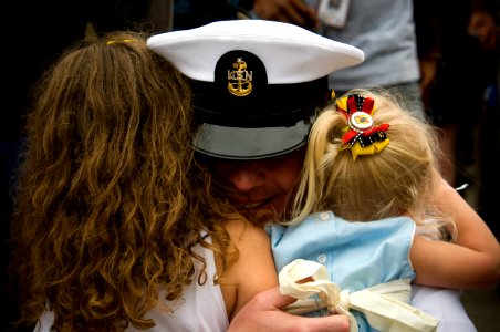 US Navy 110615-N-MD252-443 A Sailor is welcomed home by family members after returning to Naval Base Coronado