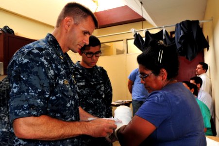 US Navy 110618-F-NJ219-230 Lt. Cmdr. Timothy Mickel, an orthopedic surgeon from Piedmont Calif., fits a patient with a cast during a surgical scree photo