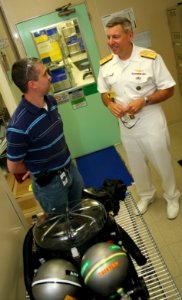 US Navy 110617-N-ZL585-152 John Austin, value stream manager at Cobham Mission Systems Division, gives Rear Adm. Thomas A. Cropper, commander of St