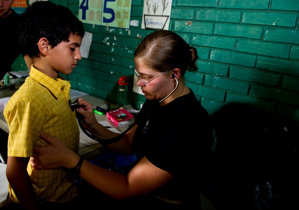 US Navy 110619-N-RM525-057 Lt. Gretchen Coady, from York, S.C., examines a patient at the Escuela Humberto Mendez Juarez medical site during a Cont