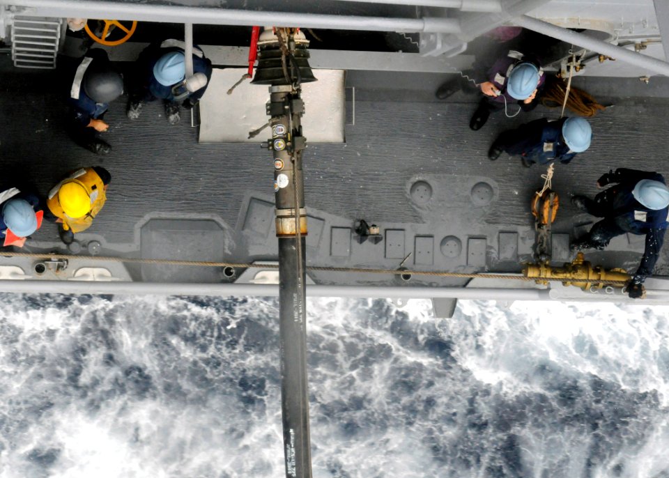 US Navy 110618-N-KB052-223 Sailors aboard the Ticonderoga-class guided-missile cruiser USS Cowpens (CG 63) stand by after a successful transfer of