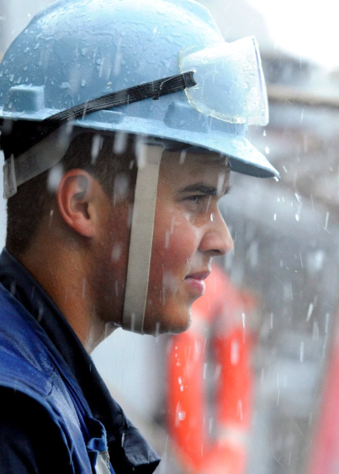US Navy 110618-N-KB052-072 Boatswain's Mate Seaman Everett Crockett, from New Bedford, Mass., watches a refueling rig approach the Ticonderoga-clas