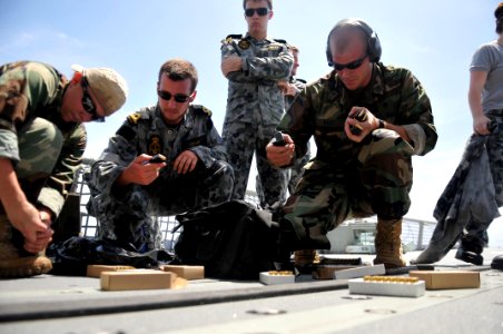 US Navy 110621-N-WW409-344 Gunner's Mate 2nd Class Joe Lopez and Gunner's Mate Seaman Michael Myers, both assigned to Naval Mobile Construction Bat