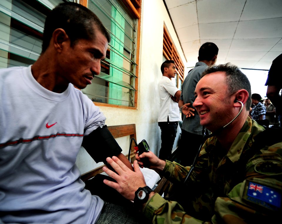 US Navy 110617-F-HS649-089 Australian Army medical assistant Cpl. David Keys checks vital signs on a Timorese man at the Zumalai medical civic acti