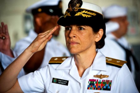 US Navy 110622-N-KK576-012 Rear Adm. Gretchen S. Herbert salutes as she is piped aboard during the Navy Cyber Forces change of command ceremony at