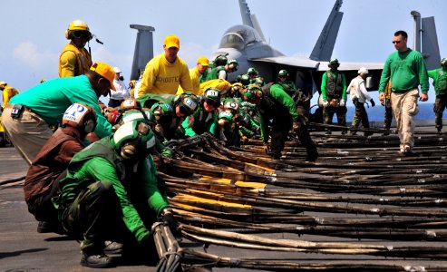 US Navy 110617-N-OP638-067 Sailors aboard USS Enterprise (CVN 65) maneuver the ready-jet barricade into position during a flight deck drill