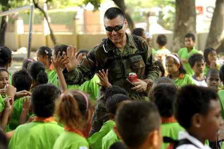 US Navy 110620-N-YM863-645 Lt. j.g. Ron Kolpak, a maritime civil affairs planner, interacts with children at the Farol primary school during Pacifi photo