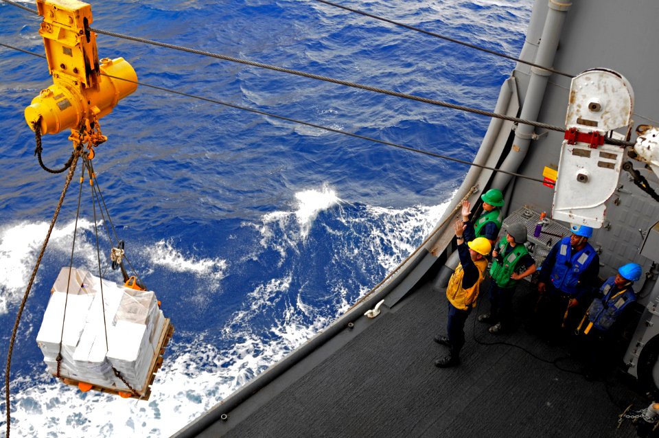 US Navy 110621-N-RC734-092 Sailors assigned to USS Comstock (LSD 45) receive supplies during a connected replenishment with USNS Tippecanoe (T-AO 1