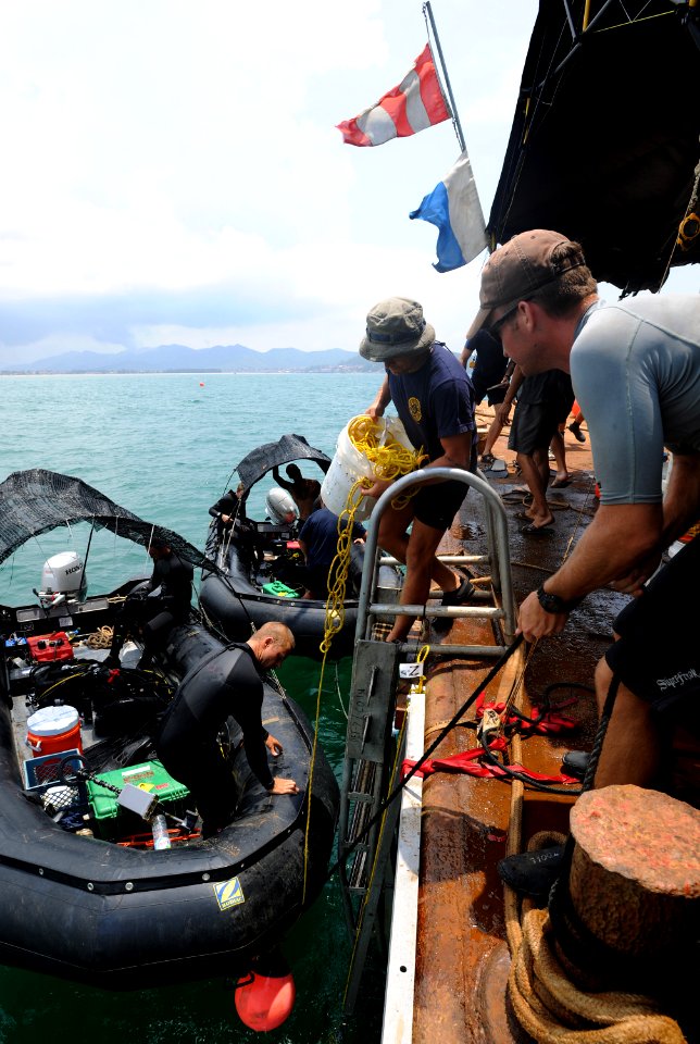 US Navy 110618-N-VF350-050 Navy Divers assigned to Mobile Diving and Salvage Unit (MDSU) 1 unload a rigid-hull inflatable boat after a series of un
