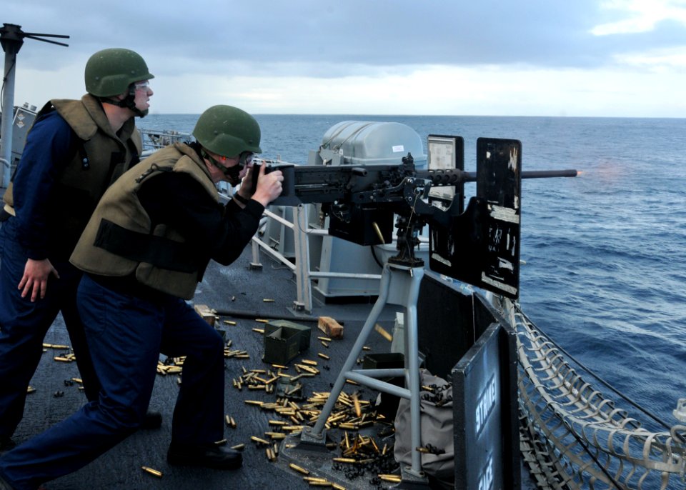 US Navy 110619-N-NL541-329 Midshipmen 2nd Class Alex Nestle fires a .50-caliber machine gun aboard the guided-missile frigate USS Thach (FFG 43)